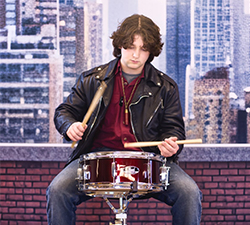 Teen boy playing the drums
