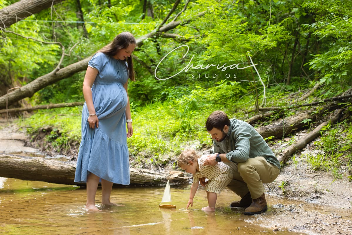 Young family playing in a shallow creek
